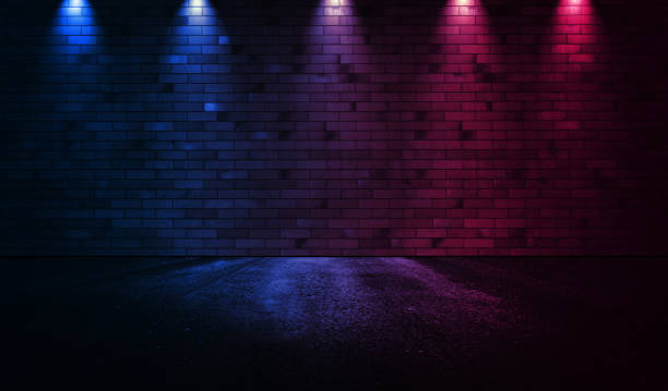 istock Neon scene empty with smoke and spotlight on  wall. Rays neon light in the dark with  smoke. 1307183930