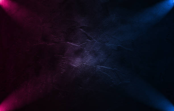 istock Neon scene empty with smoke and spotlight on  wall. Rays neon light in the dark with  smoke. 1307183939