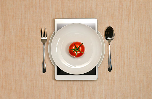 Online ordering food, food and ready meals. Serving on a person with a tomato.