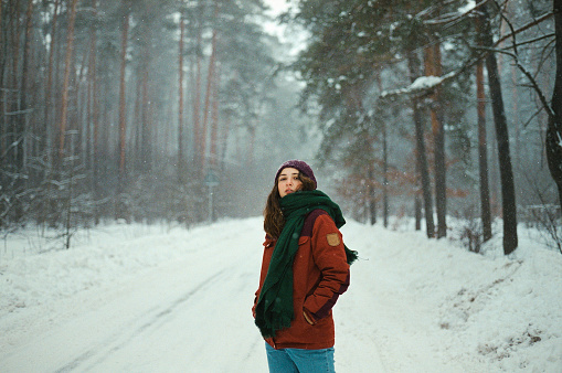 Young Caucasian woman in winter forest
