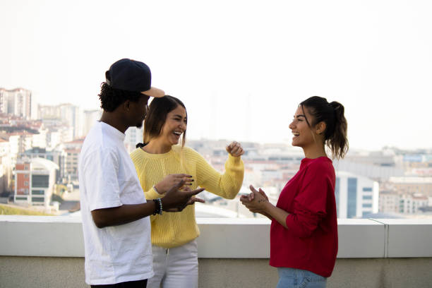 istock Multi-ethnic group of young people on a rooftop party 1307185482