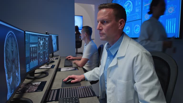 DS Male radiologist analysing an MRI head image on his computer