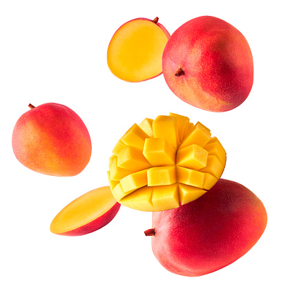 Fresh ripe mango falling in the air isolated on white background. Food levitation concept. High resolution image