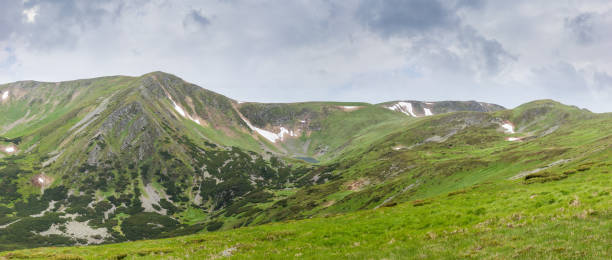 istock Mountain range with mountain lake against the sky with clouds 1307190535