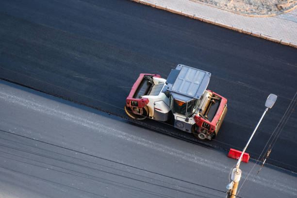istock Asphalt road roller with heavy vibration roller compactor press new hot asphalt on the roadway on a road construction site. Heavy Vibration roller at asphalt pavement working. Repairing. 1307190644