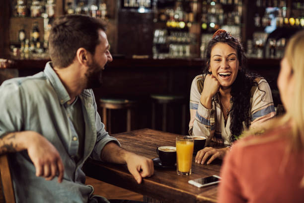 istock Young happy friends having fun while talking in a cafe. 1307190684