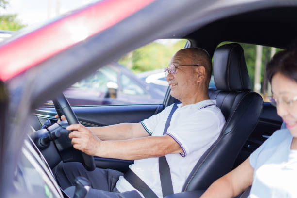 istock Senior couple driving a car 1307191876