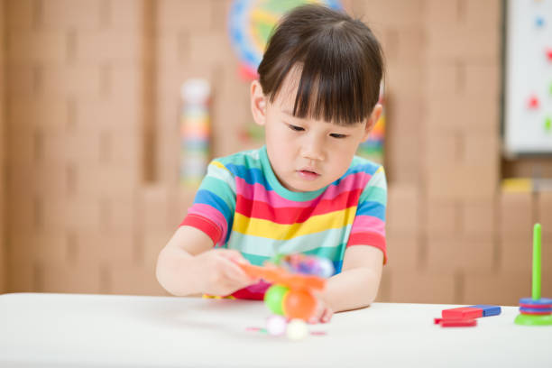 istock Cute Girl Playing With Toy At Home 1307192485