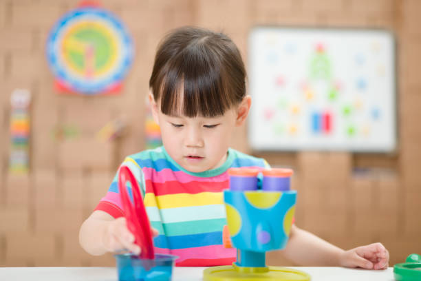 istock Cute Girl Playing With Toy At Home 1307192496