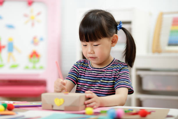 istock Cute Girl Learning Craft At School 1307192498