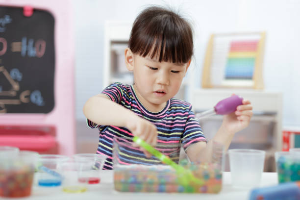 istock Cute Girl Playing With Toy At Home 1307192593