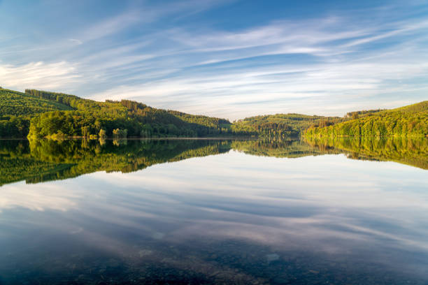 istock Long exposure at the lake with colorful trees and moving clouds. 1307193449