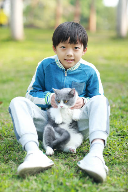 istock Cute young boy snuggles his kitten. 1307194016