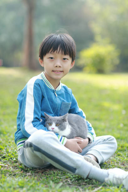 istock Cute young boy snuggles his kitten. 1307194055