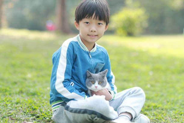istock Cute young boy snuggles his kitten. 1307194076