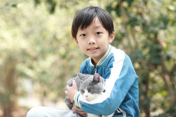 istock Cute young boy snuggles his kitten. 1307194683