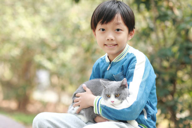 istock Cute young boy snuggles his kitten. 1307194687
