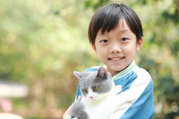 istock Cute young boy snuggles his kitten. 1307194741