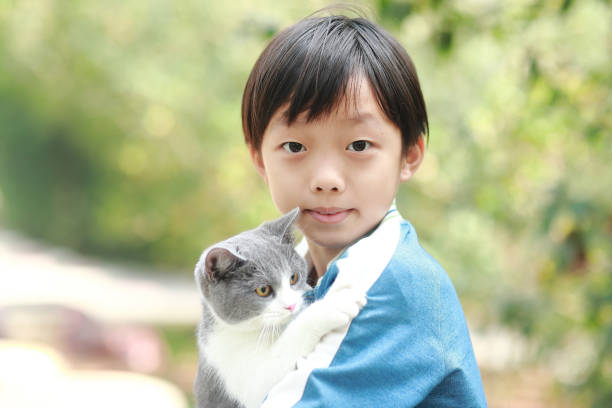 istock Cute young boy snuggles his kitten. 1307194761