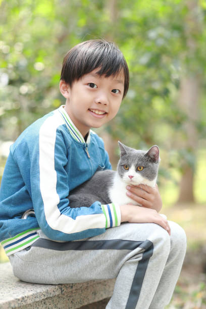 istock Cute young boy snuggles his kitten. 1307194778