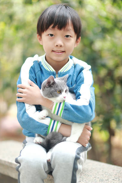 istock Cute young boy snuggles his kitten. 1307194847