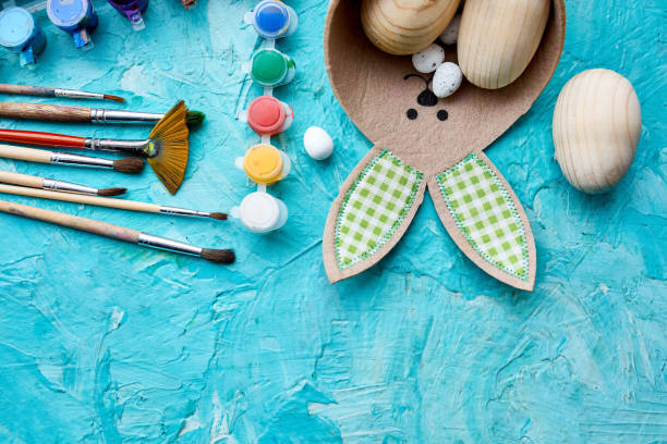 istock Top view pack of eggs with brush, paint and decorative elements 1307196162