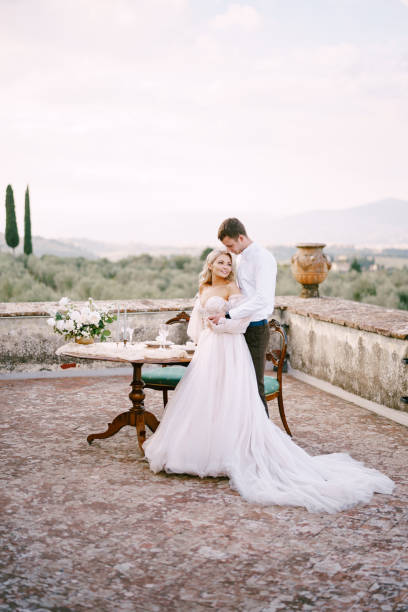 istock Full Length Of Couple Embracing While Standing Against Sky 1307196936