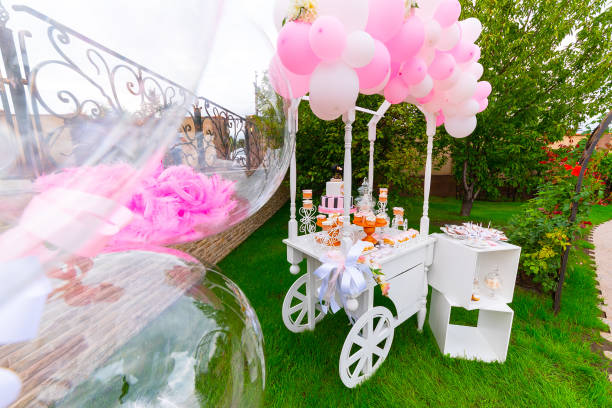 istock Candy Bar. White wooden trolley with sweets decorated with balloons 1307197373