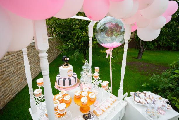 istock Candy Bar. White wooden trolley with sweets decorated with balloons 1307197669