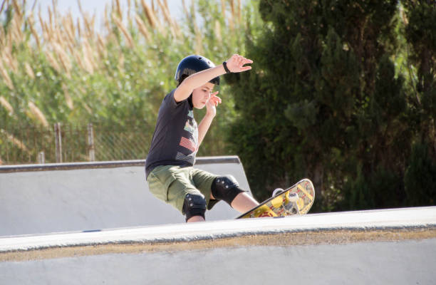 istock Teenage boy in skateboard park against blue sky 1307197708