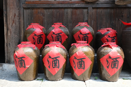 close up many traditional Chinese wine jars. Chinese character translation is wine