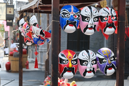 Haikou.China-March 2021: various colorful Peking opera masks on street stall. Beautiful Chinese opera mask