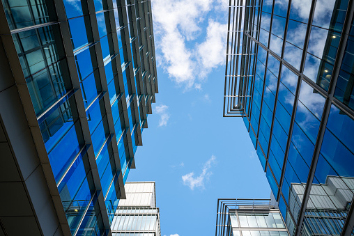 Modern office exterior facades with clouds reflections. Abstract business background