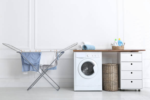 istock Clean laundry hanging on drying rack indoors 1307208135