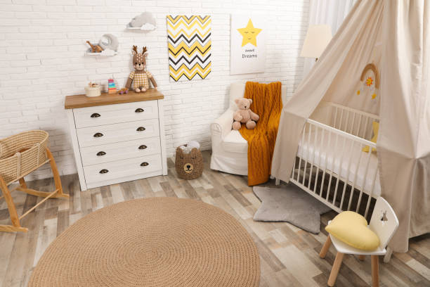 istock Stylish baby's room with comfortable cot. Interior design 1307208139