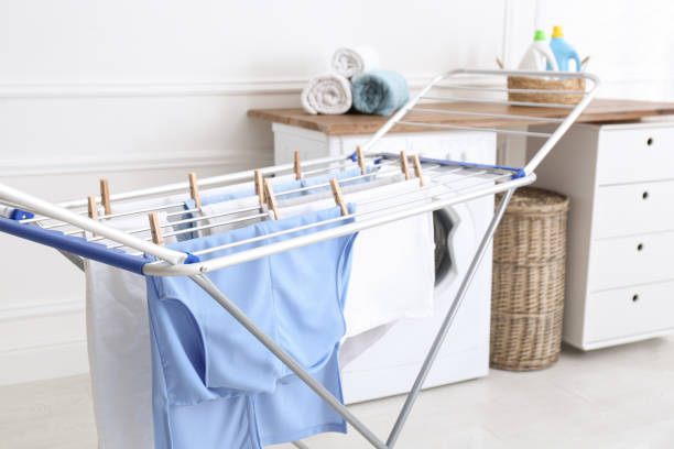 clean laundry hanging on drying rack indoors - clothesline imagens e fotografias de stock