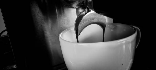 Coffee machine making fresh coffee. Black and white photo.