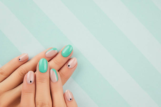 istock Womans hands with trendy turquoise manicure with copy space 1307210535