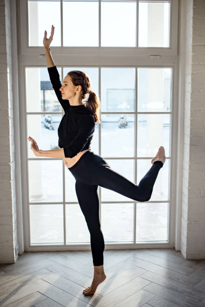Woman doing dance in living room stock photo