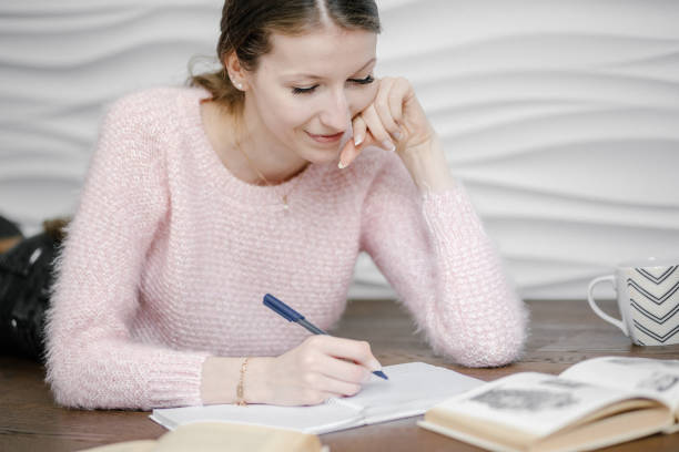 istock girl sit on floor reading book 1307211161