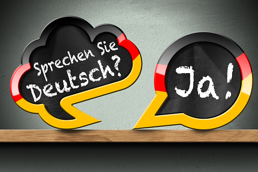 Sprechen Sie Deutsch and Ja - Two Speech Bubbles on Wooden Shelf