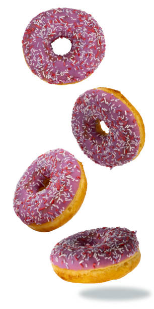 istock flying donuts isolated on white background. selective focus. multicolored crumpets. set of sweet doughnuts, traditional confectionery products. icing sugar with sprinkles. 1307213785