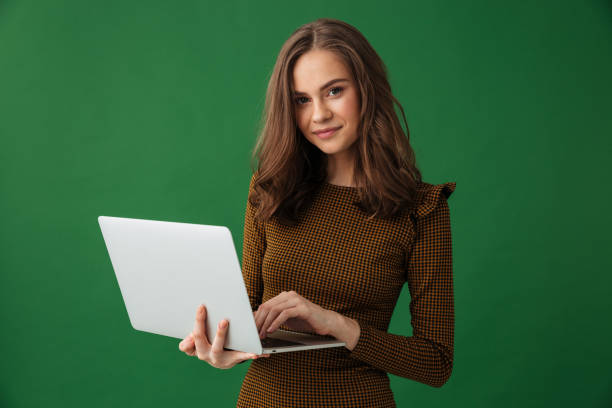 istock Young cheerful woman holding laptop computer. 1307215098