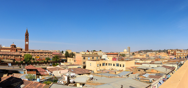 Asmara, Eritrea: downtown cityscape - view from Mata Street, with a neoclassical facade in Nafka Avenue and a Novencento building on Selam Street. Kidane Mihret Catholic cathedral Holy Trinity / Kidist Selassie Orthodox Tewahido Church on the horizon and the Catholic Church of Our Lady of the Rosary ('cathedral') on the left - Asmera, a Modernist City of Africa - UNESCO World Heritage Site.