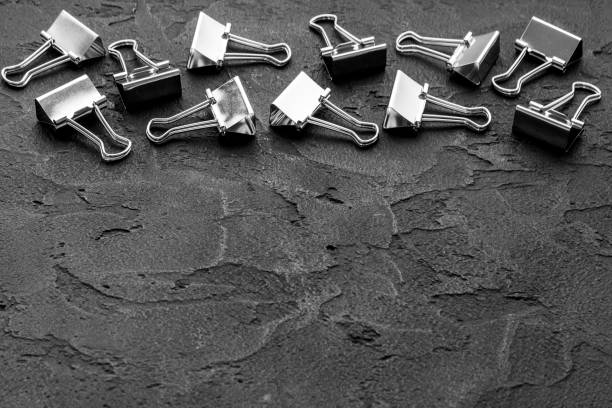 istock Office supplies background - paper binder clips close up 1307216017