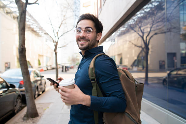 istock Young man using his mobile phone outdoors. 1307216300