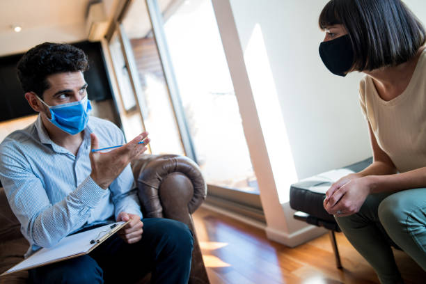 istock Psychologist talking with patient on therapy session. 1307216335