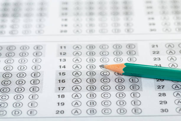istock testing in exercise and exam paper. computer sheet with pencil in school test room, education concept 1307217798