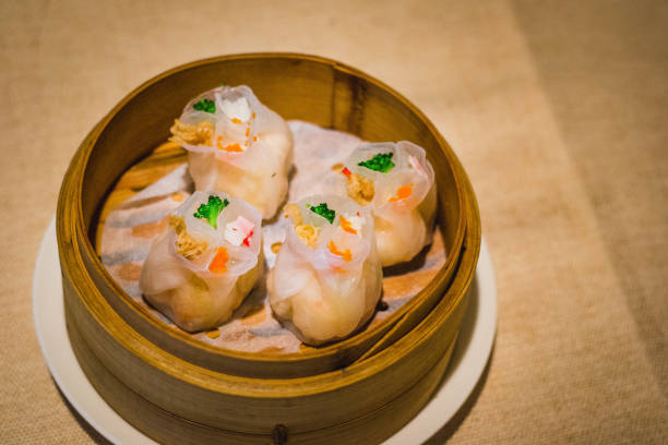 istock a bamboo basket filled with four steamed dumplings with white translucent skin 1307219044