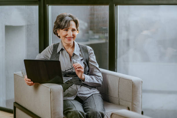 istock Mature business woman talking with somebody using laptop 1307223032